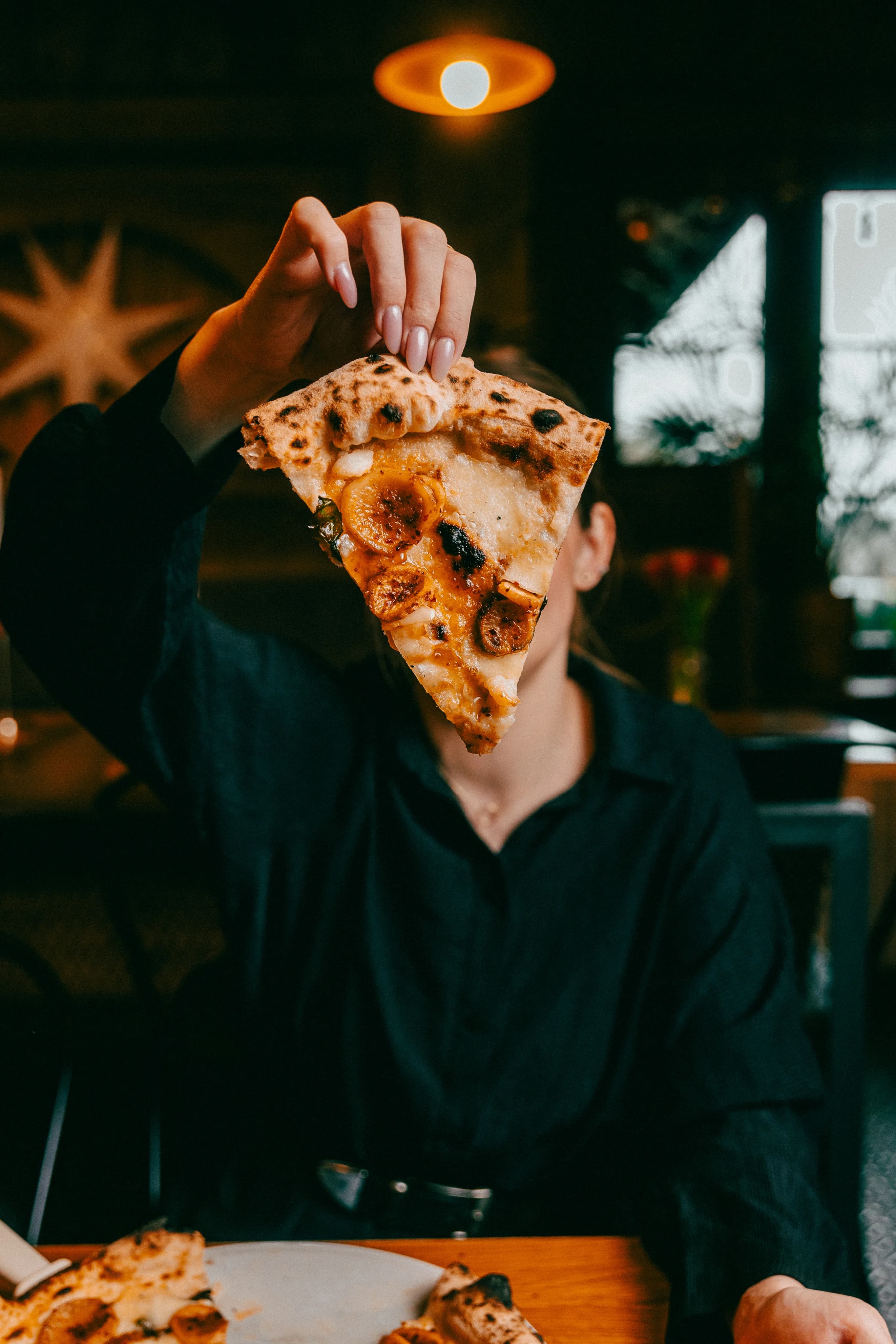 Gość Stacji Neapol z kawałkiem pizzy w dłoni